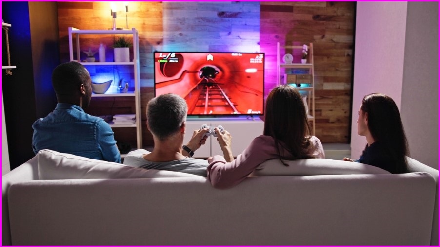 People on a couch playing video games
