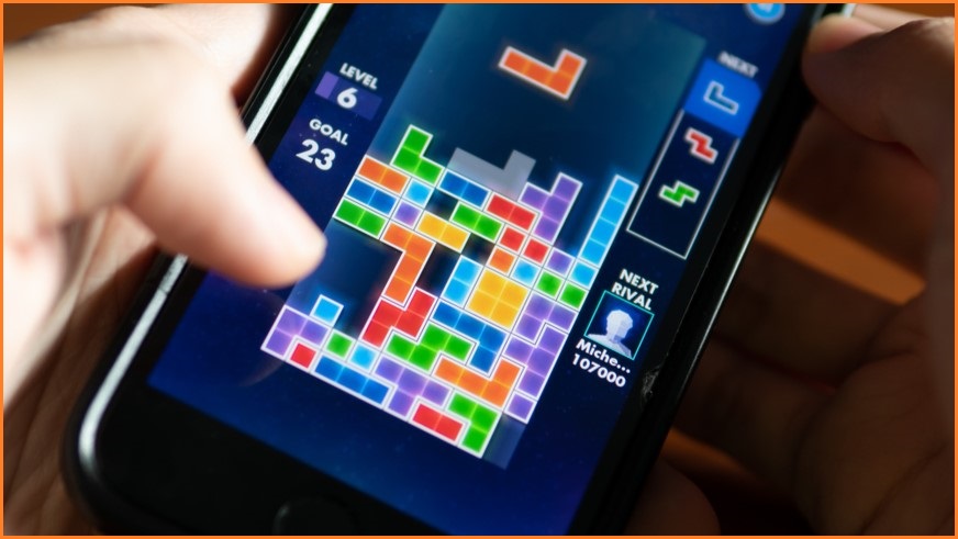Person playing Tetris on phone