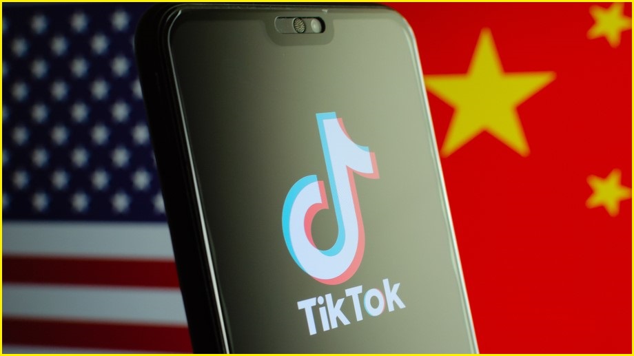 US and China flags, mobile phone with tiktok logo on phone screen