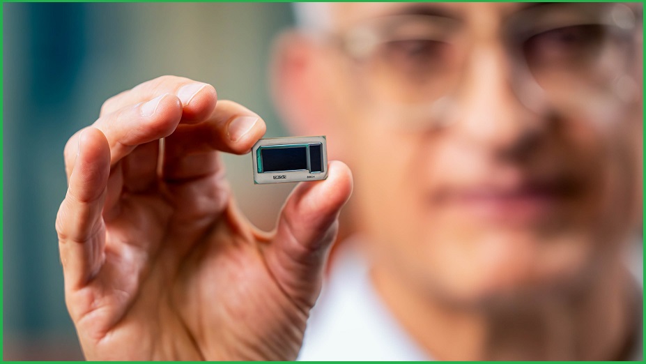 An Intel vice president holding up a small computer chip
