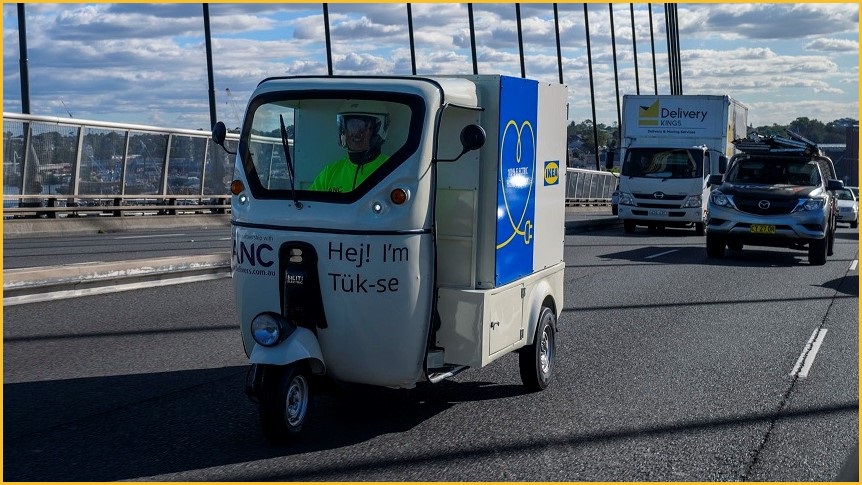 An IKEA tuk tuk travelling across Sydney's Anzac Bridge