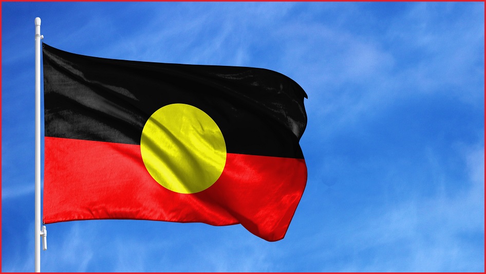 Aboriginal flag flying against a blue sky