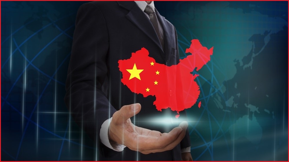 Man in business suit holding floating map of China