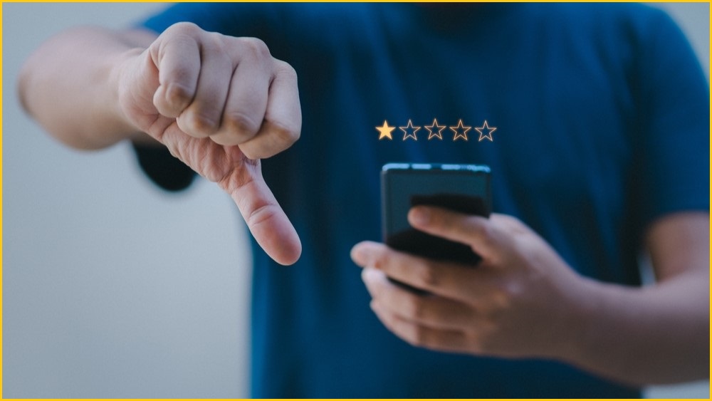 Person giving a one-star review and showing his thumb pointing down