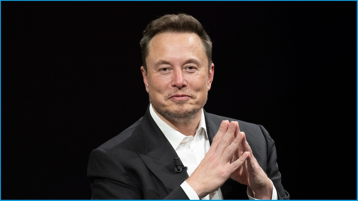 A photo of Elon Musk against a black background.