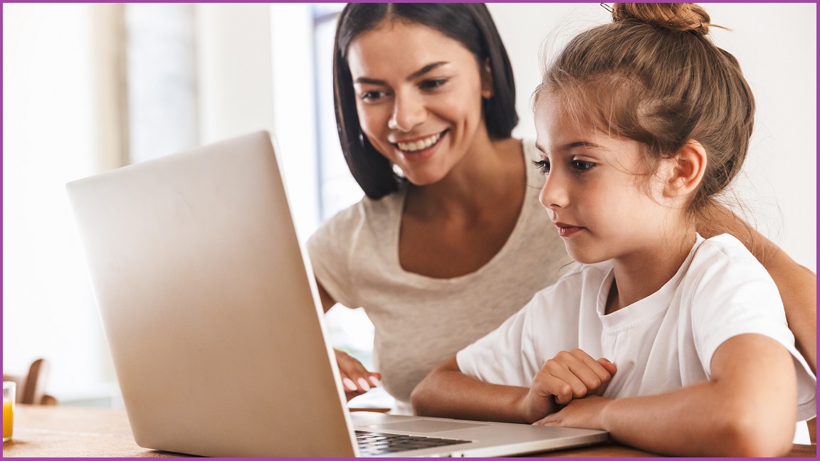 A mother and her daughter looking at an open laptop screen.