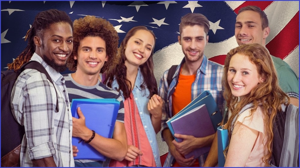 group of graduates standing in front of american flag