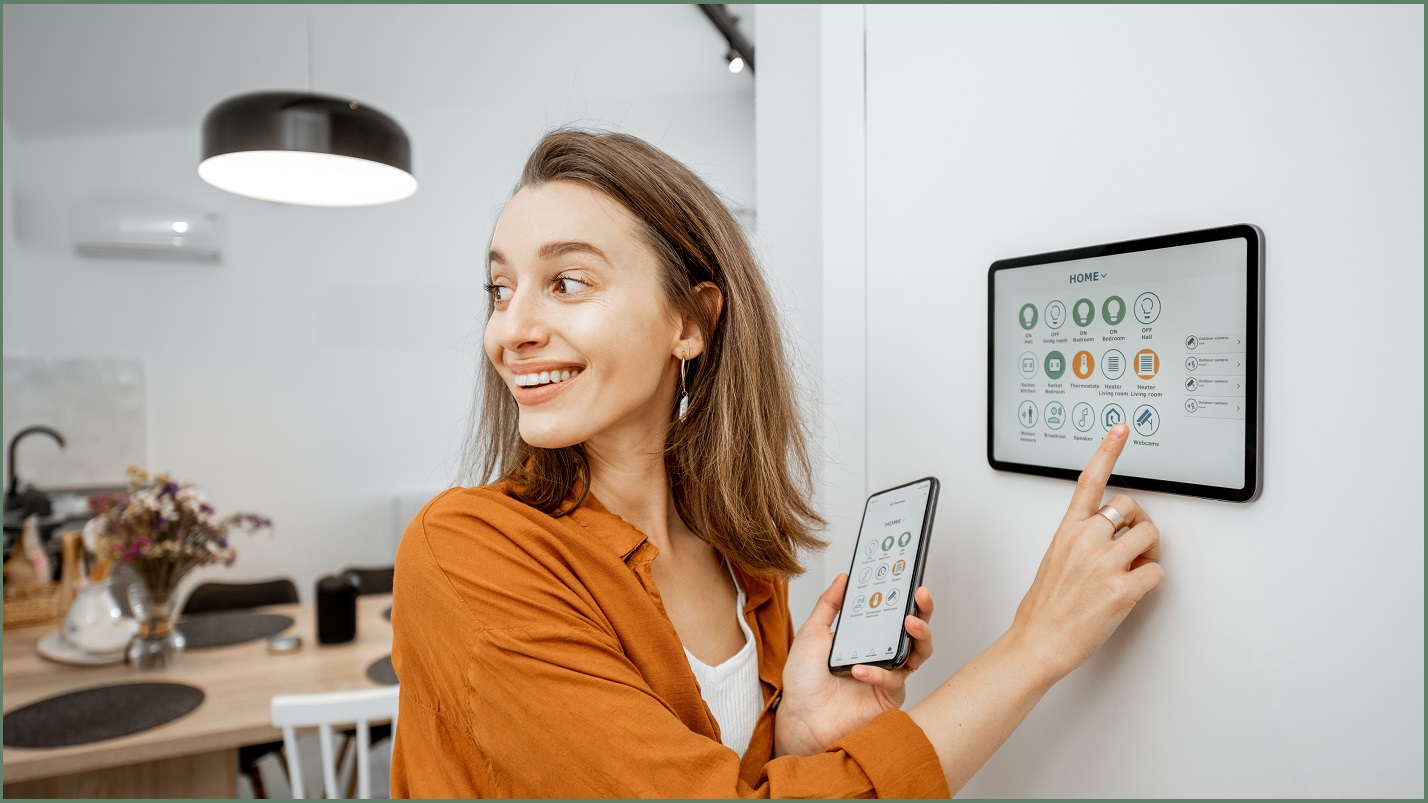 A woman standing at her smart home interface.