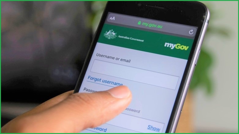 person's thumb on mobile phone screen using mygov app