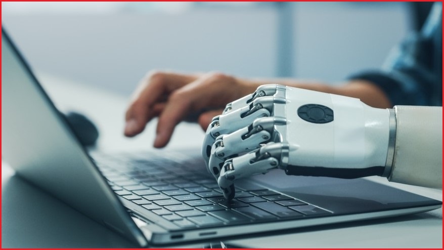 Human hand and robot hand typing on keyboard