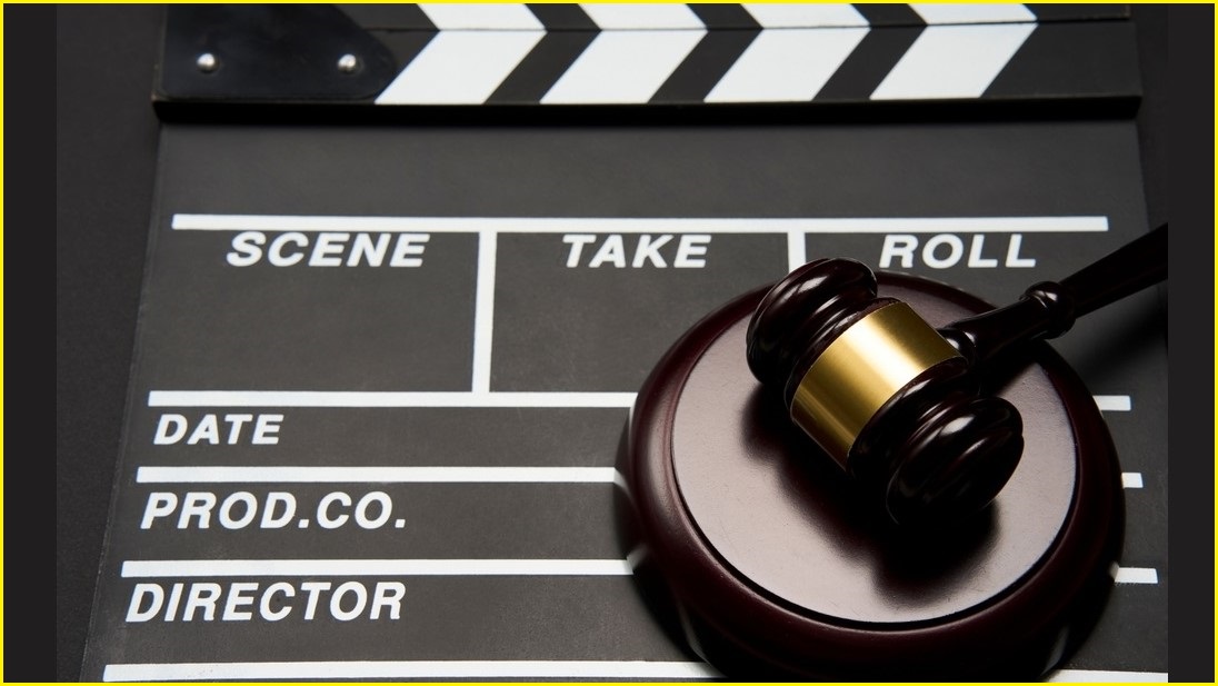 movie clapperboard with judge's gavel on top