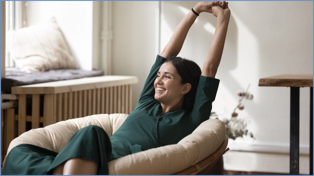 Woman relaxing in a big comfy chair.