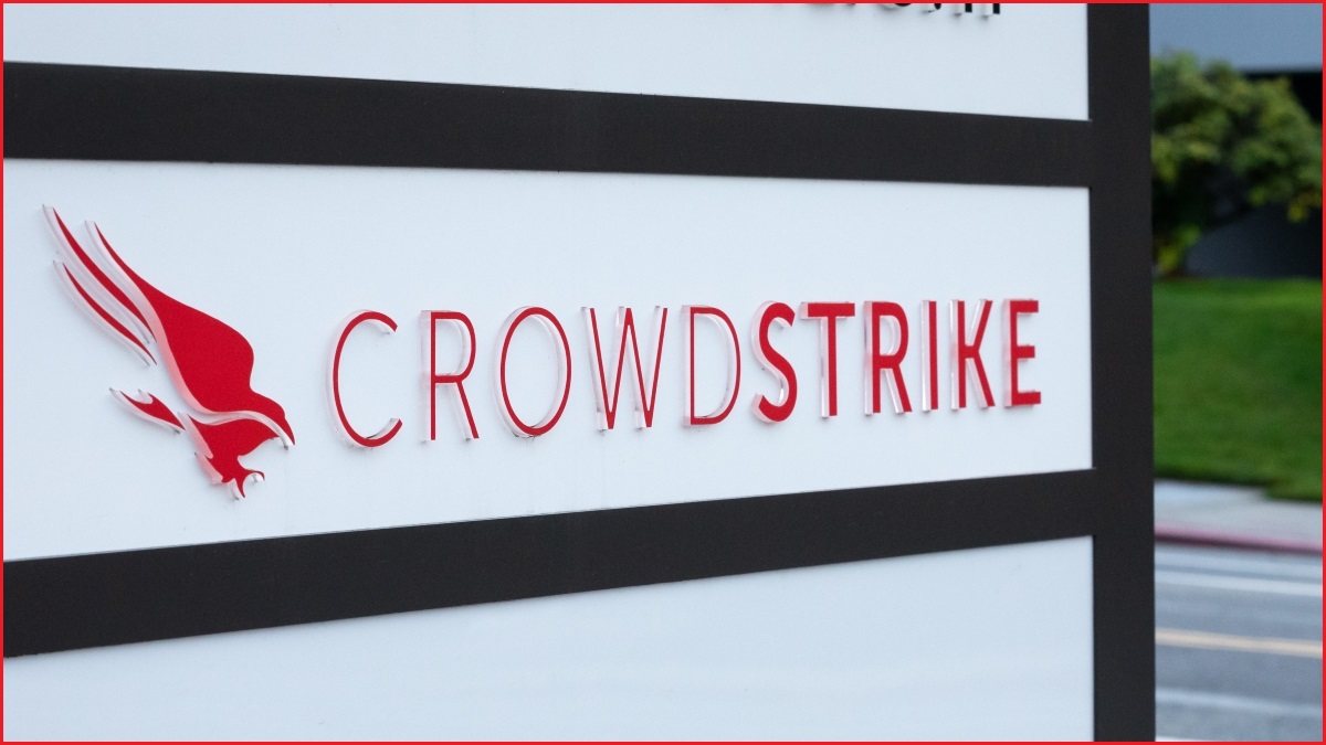 A close up of the CrowdStrike logo, featuring a flying bird, on the side of a large plinth next to a road.