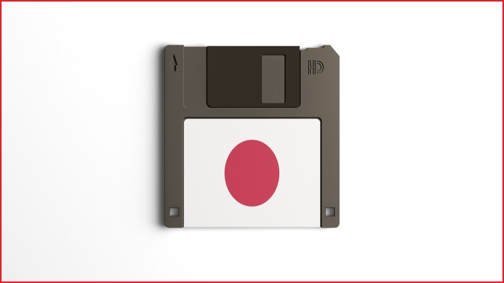 A close up of a floppy disk with a Japanese flag on it.