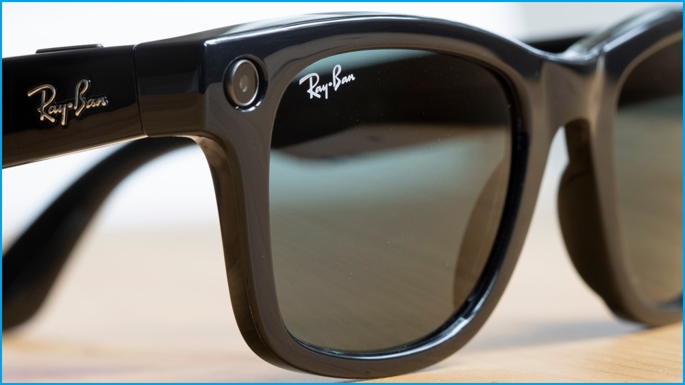 A close up of a pair of Meta Ray-Ban smart glasses sitting on a surface.