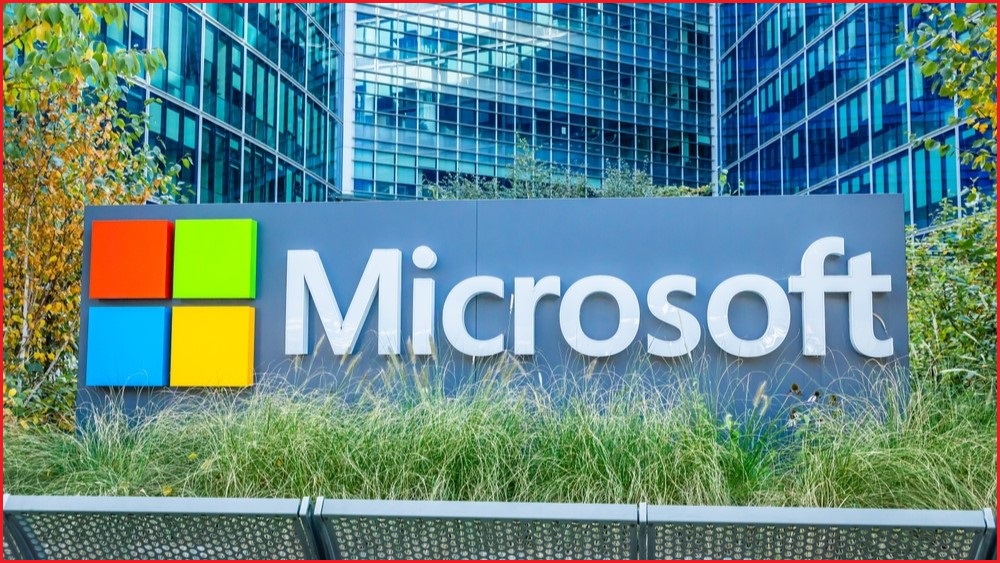 A shot of a Microsoft logo and sign out the front of a large office building