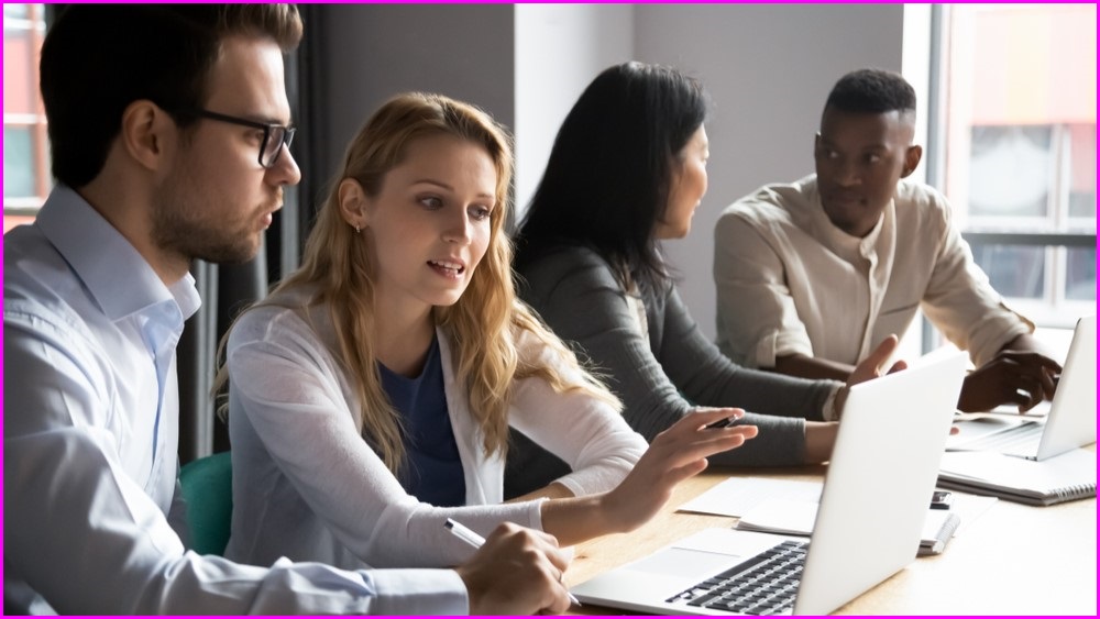 Men and women studying at computers