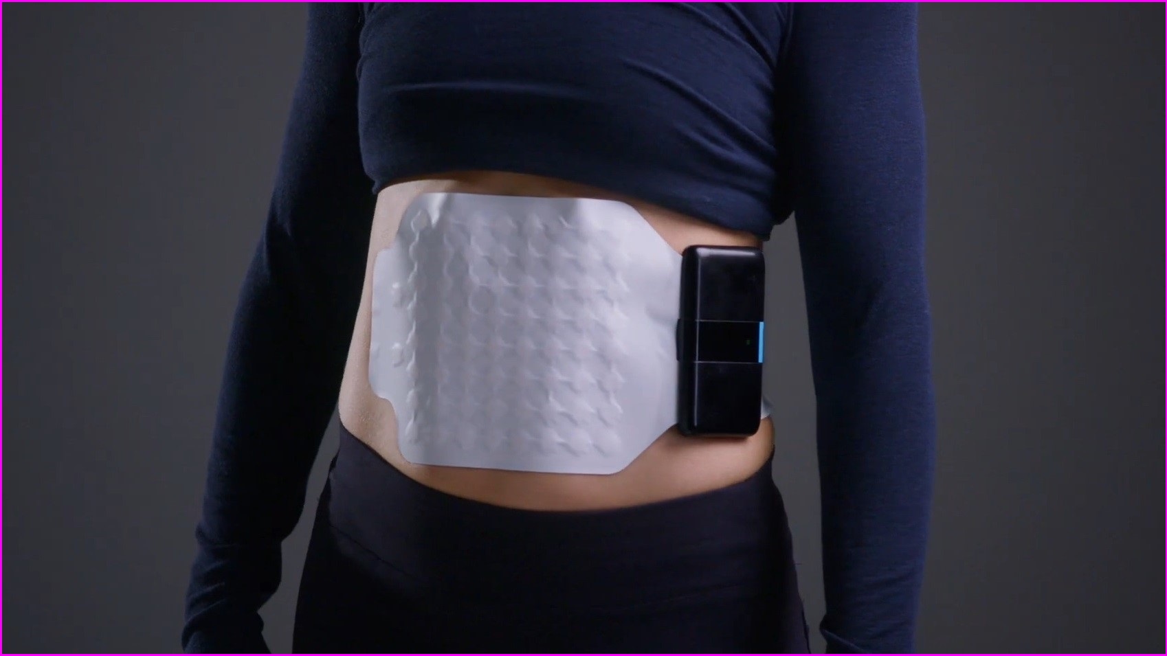 A wearable diagnostic device stuck on someone's tummy area.