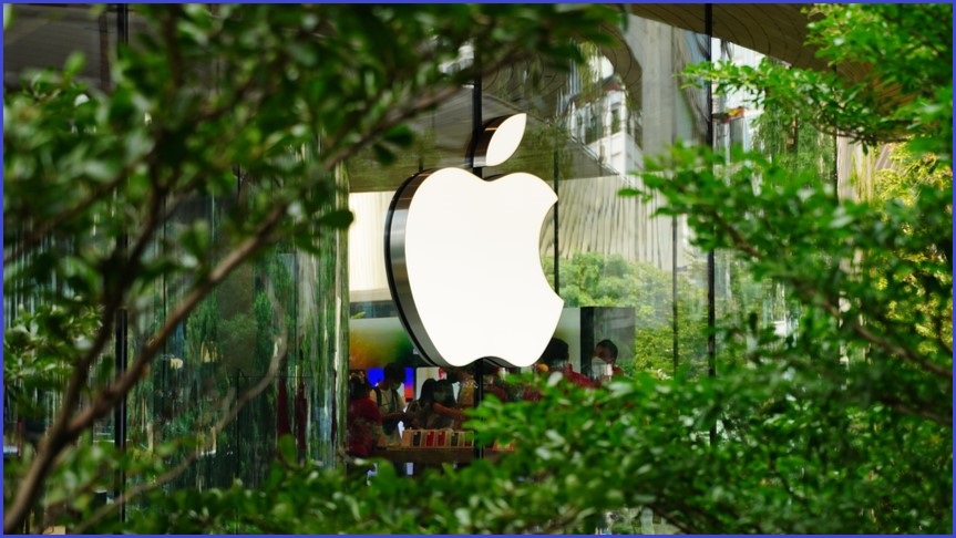 Apple logo on a building surrounded by greenery