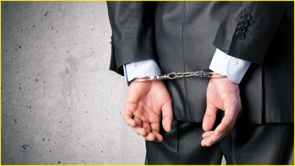Man in suit handcuffed