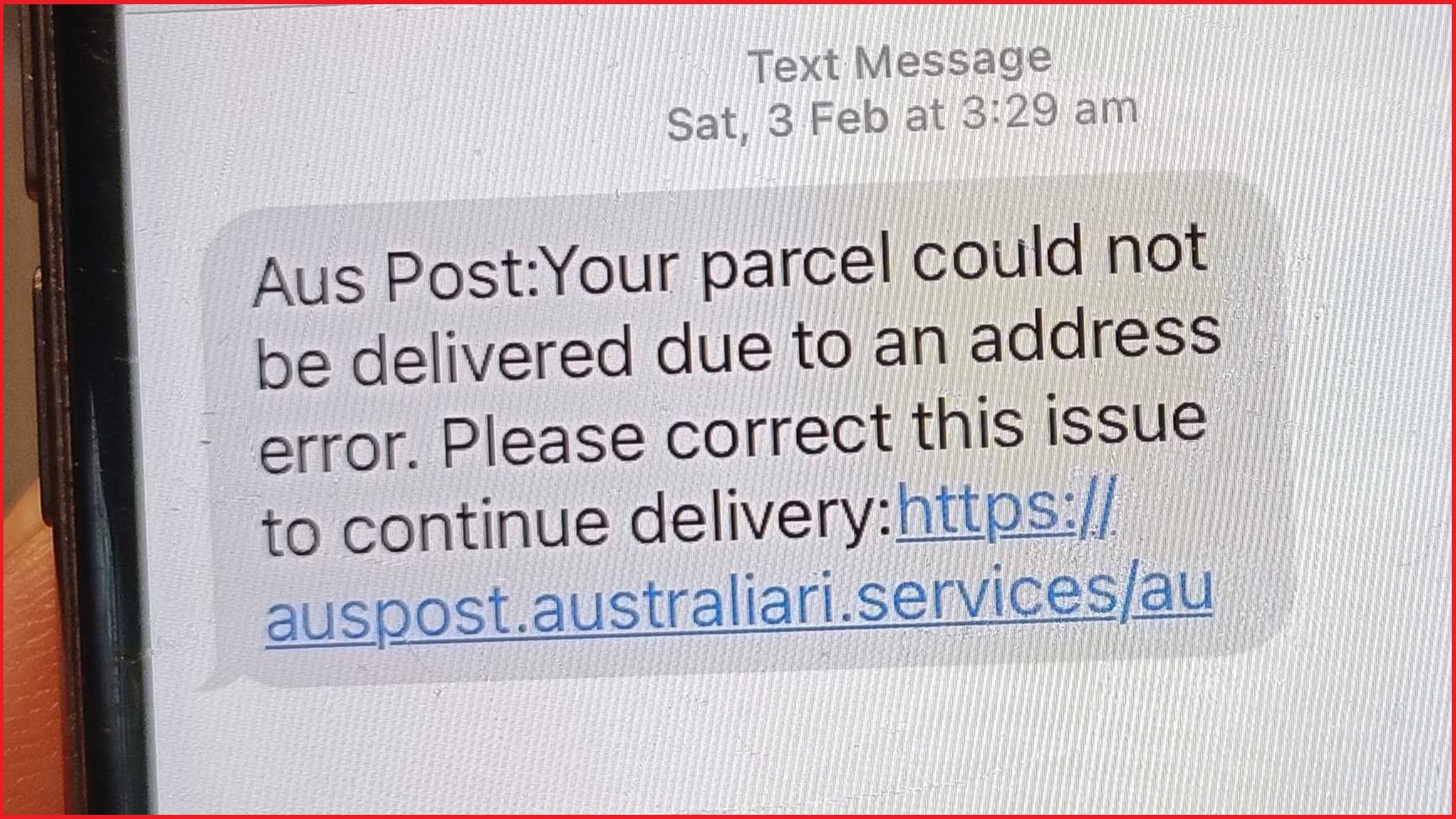 AusPost scam message on  mobile phone screen