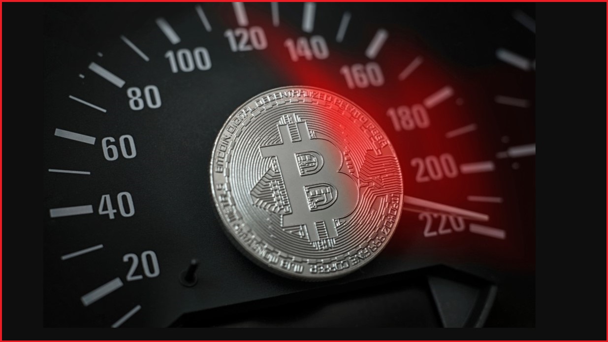 A silver bitcoin on a car dashboard