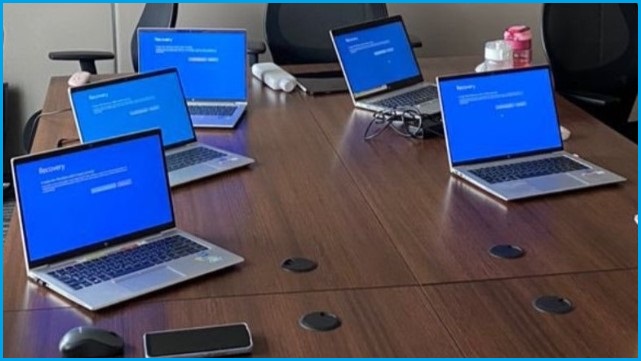 A bunch of Windows laptops all displaying blue screens of death