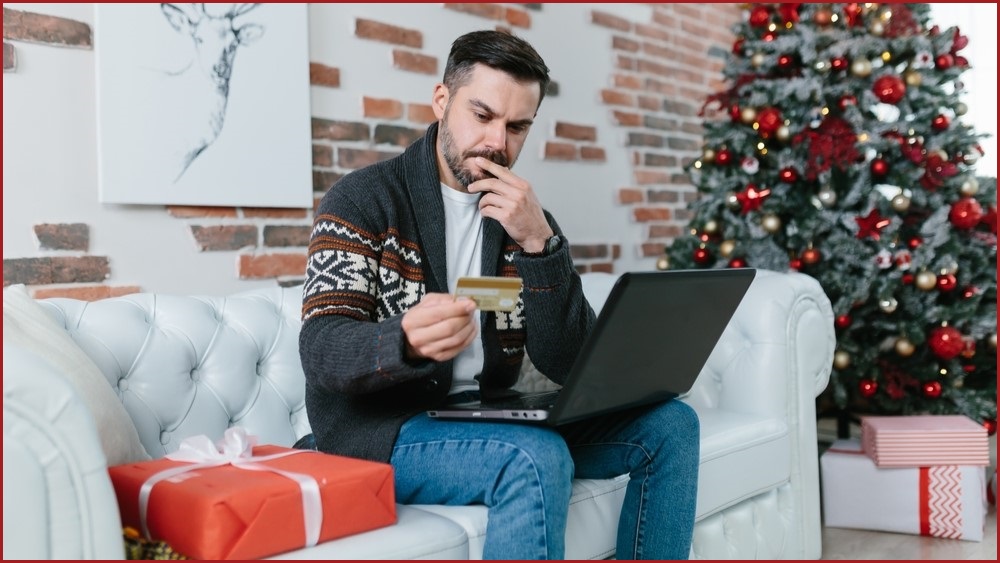 Concerned man doing online Christmas shopping.