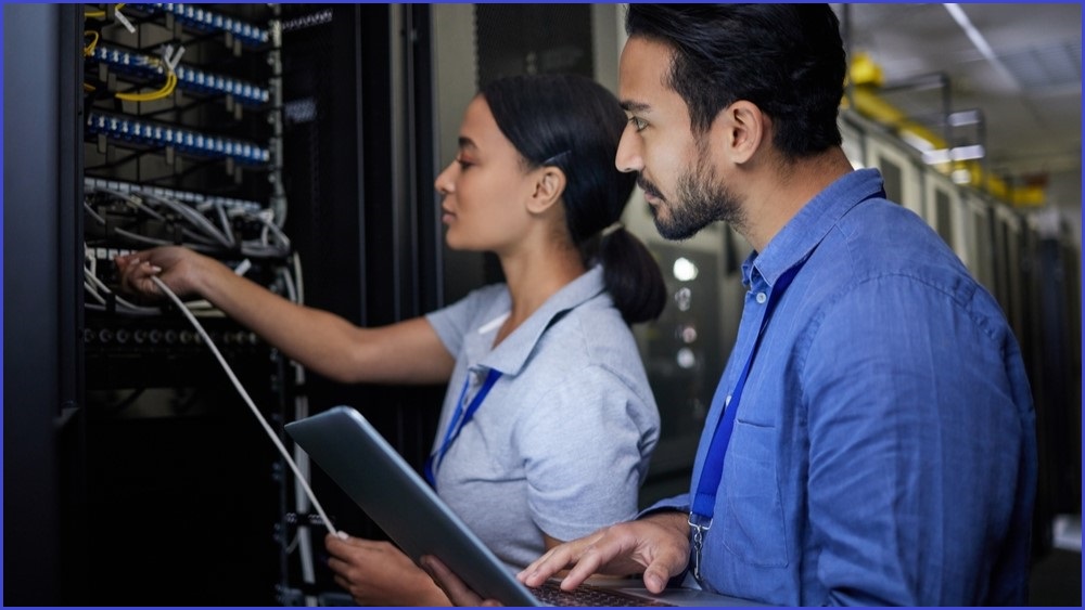 Man and woman examining a server.