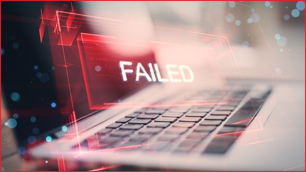 The word FAILED floating above a laptop computer keyboard.