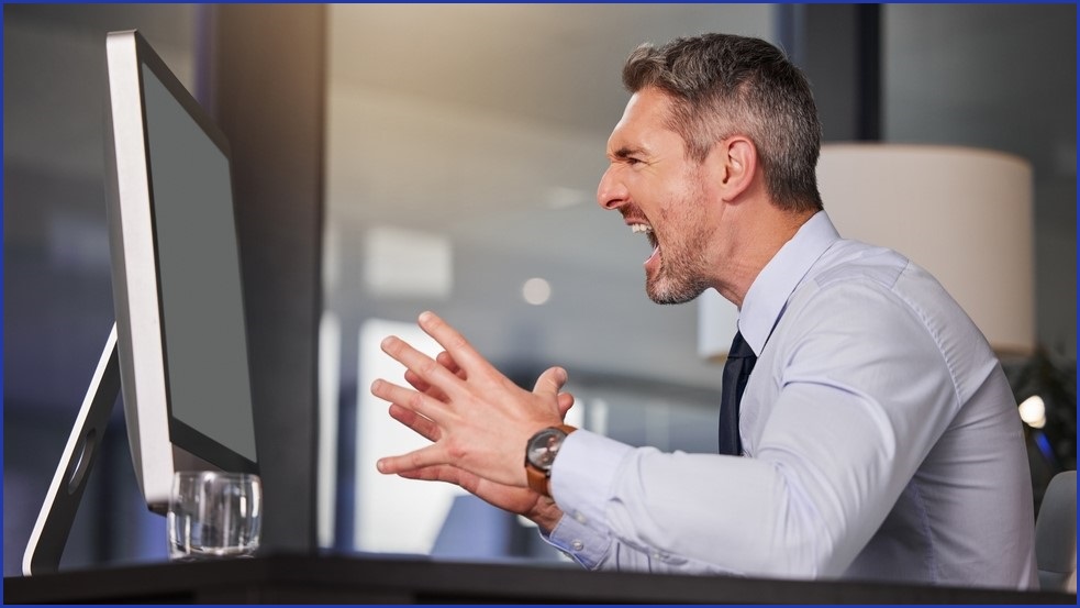 Man screaming at computer.