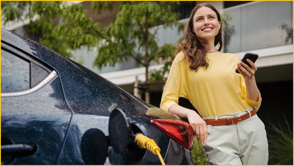 Woman charging her electric vehicle.