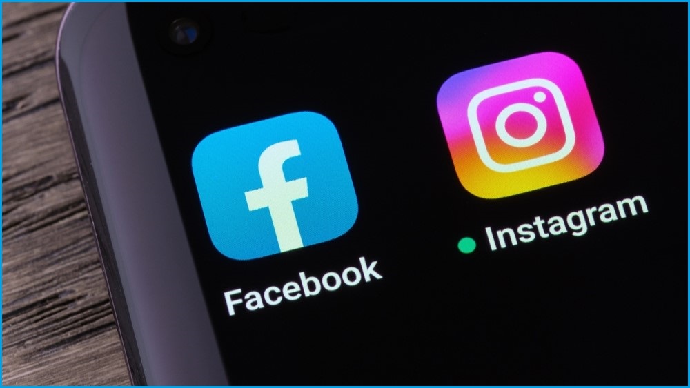 A close up of a smartphone screen showing Facebook and Instagram's app icons.