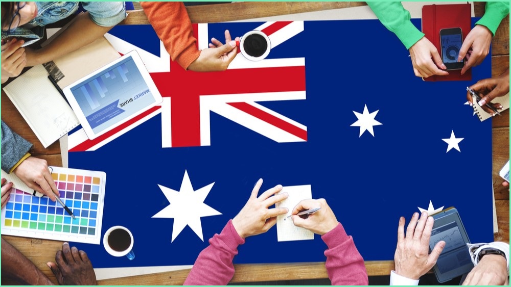 People working around a table which has an Australian flag as a tablecloth.