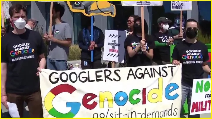 Protesting Google employees holding signs