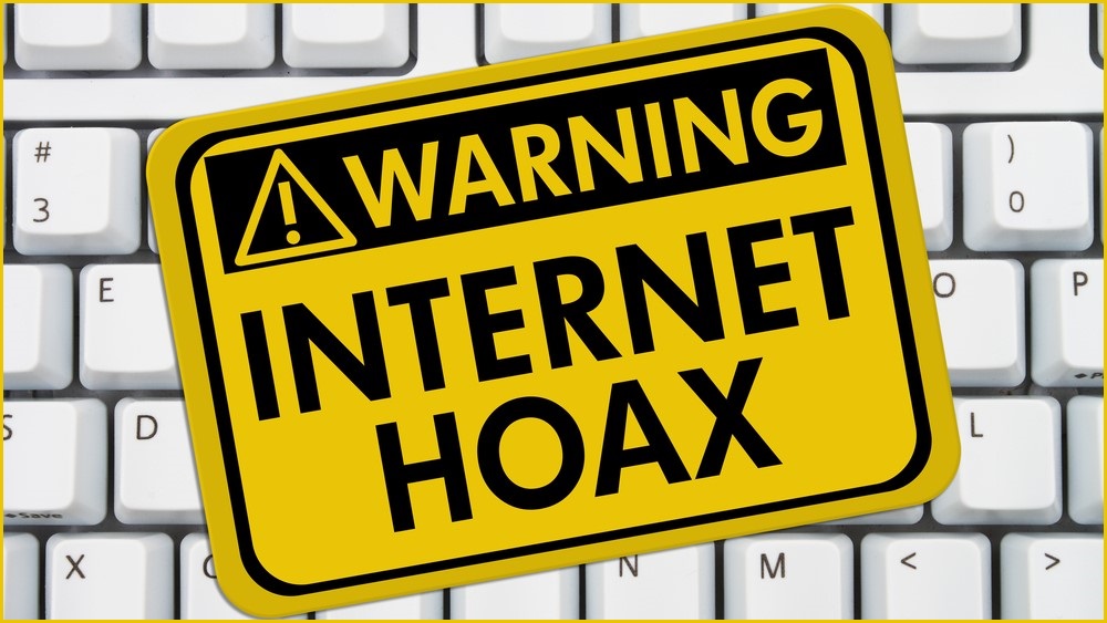 keyboard with a sign WARNING: INTERNET HOAX on top