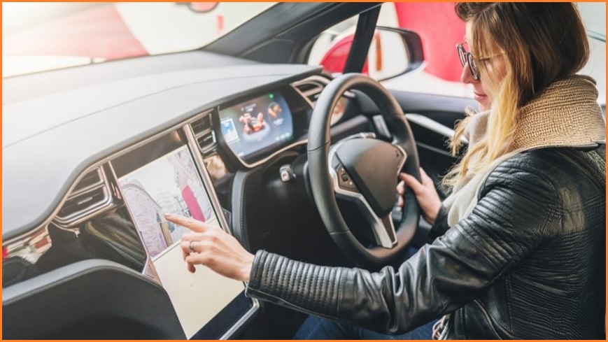 Woman inside a card using the in-car navigation system.