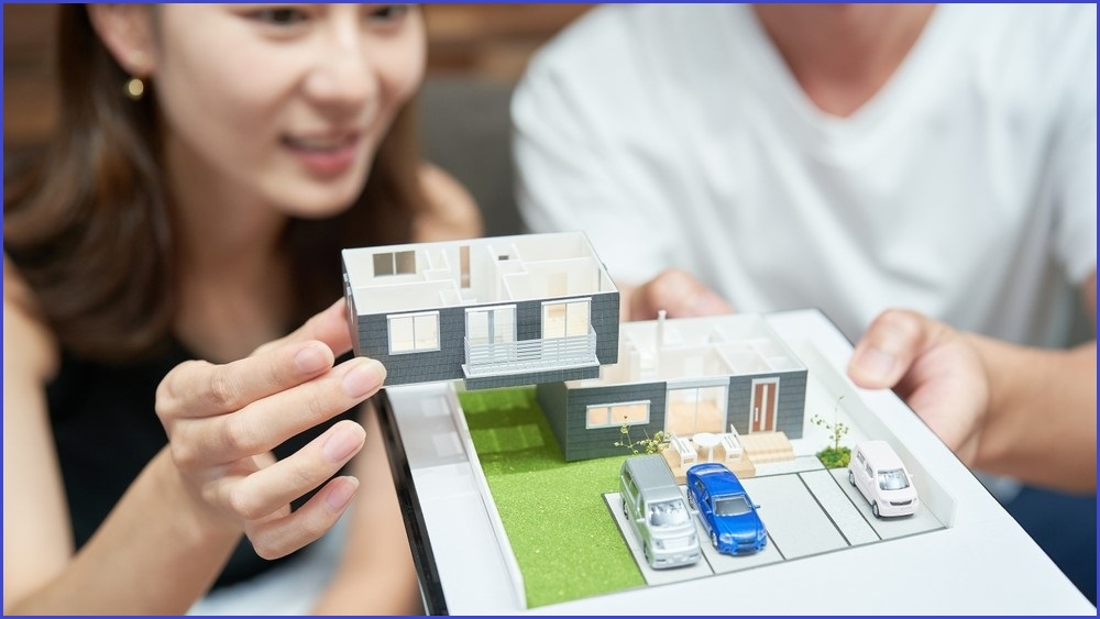 Couple looking at a model of a home.