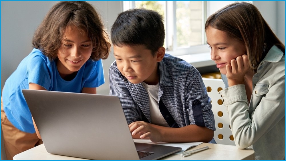 Three children looking at a laptop screen