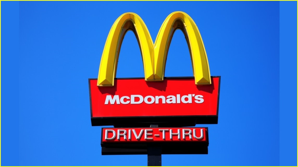 McDonald's sign featuring the yellow arches and the word DRIVE-THRU