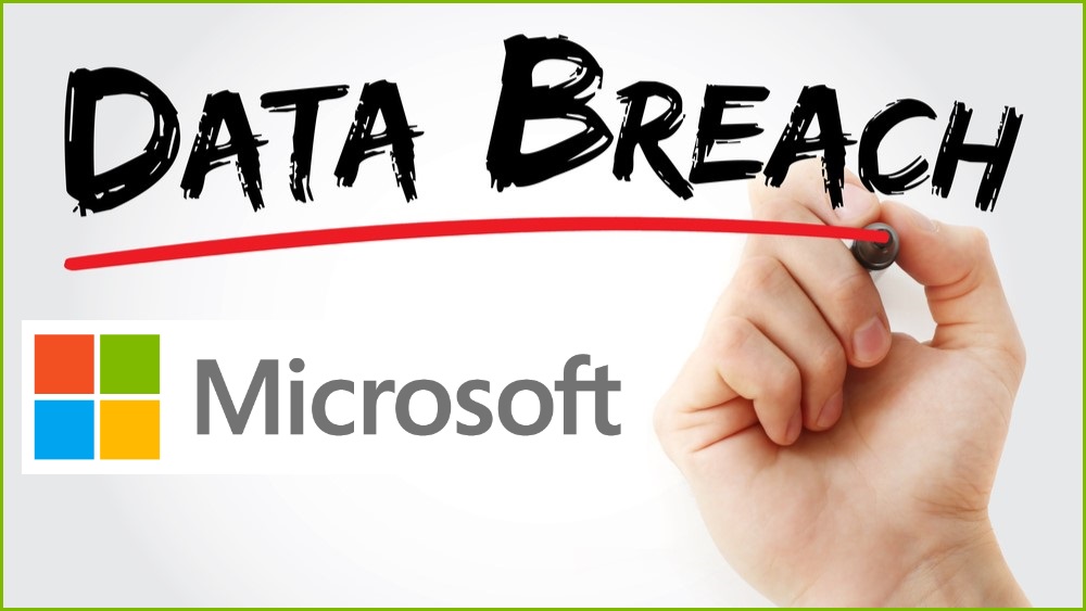 Photo of a hand writing the word DATA BREACH on a board with the Microsoft logo beneath