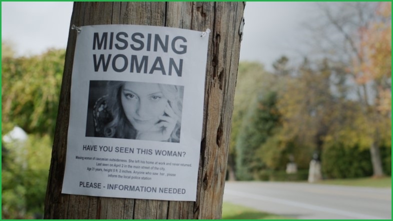 Missing woman poster pinned to a telegraph pole