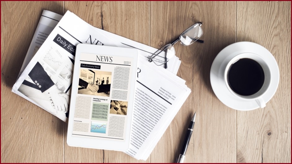 Newspaper on table with coffee nearby