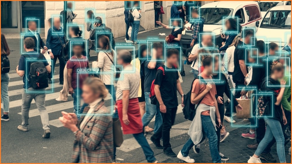 People crossing a road with facial recognition tech over their faces.