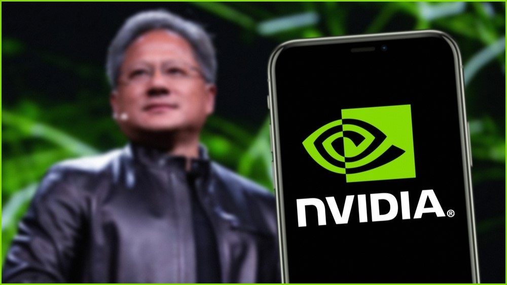 Nvideo CEO Jensen Huang next to a phone with the Nvidia logo on the screen.