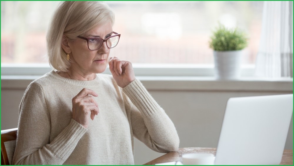 Confused woman looking at a computer screen.