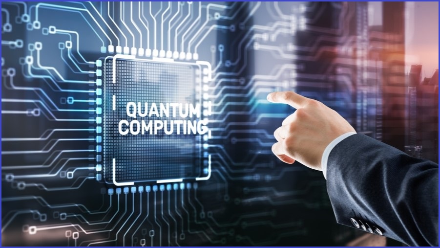 Finger touching a screen saying 'quantum computing'