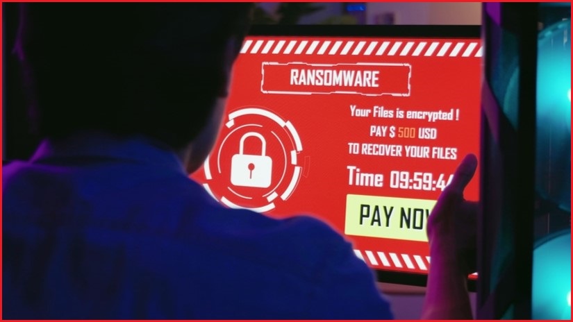 Person looking at a computer screen with a ransomware message.