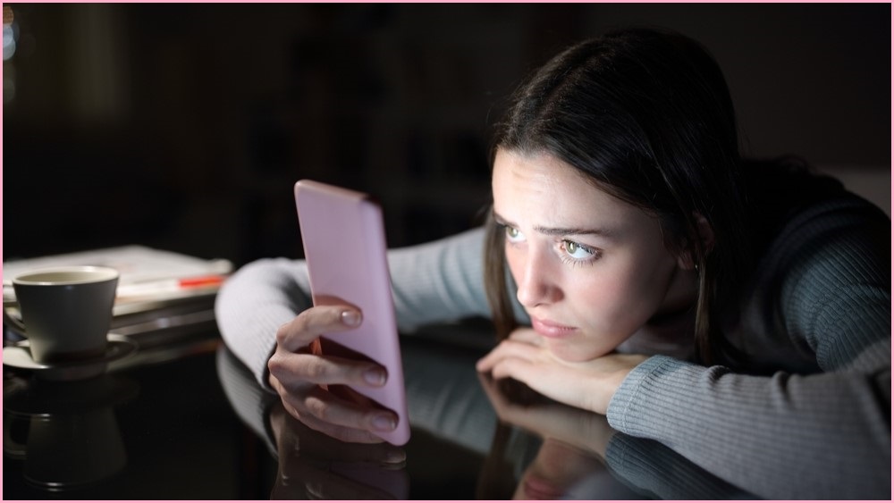 Woman look at mobile phone screen, depressed.