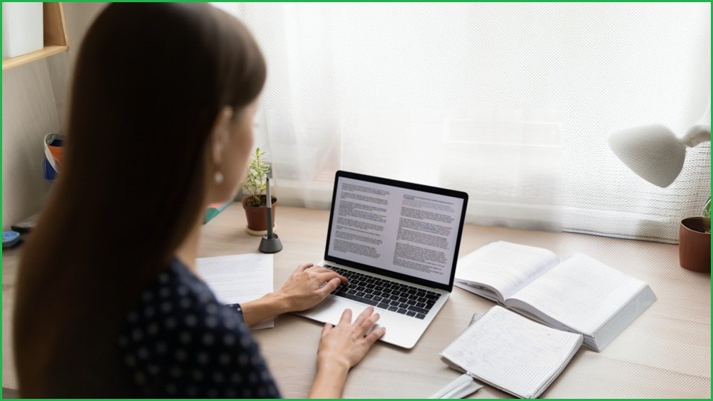 Young woman doing work on a laptop.